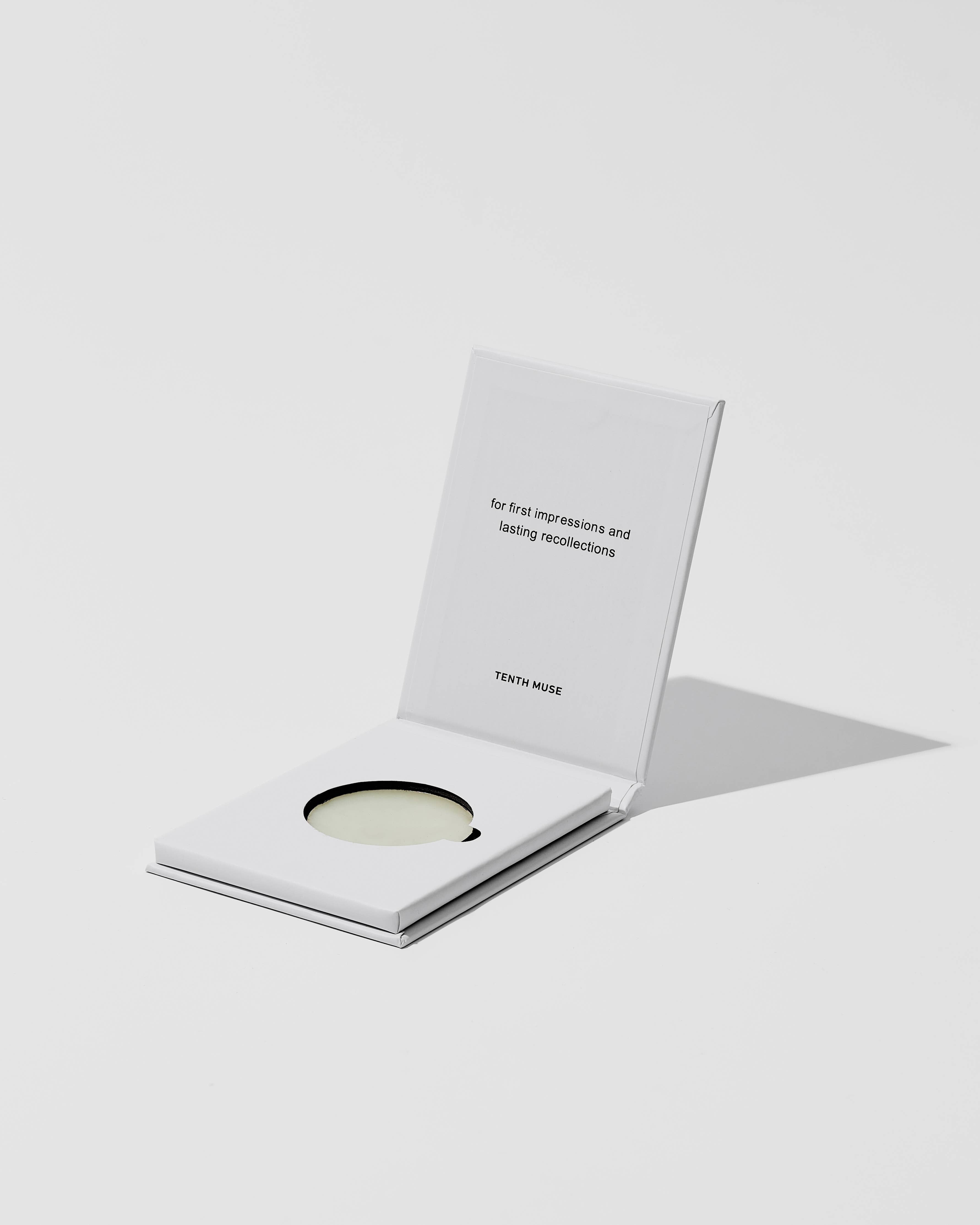Product packaging with a card and a disc on a white background