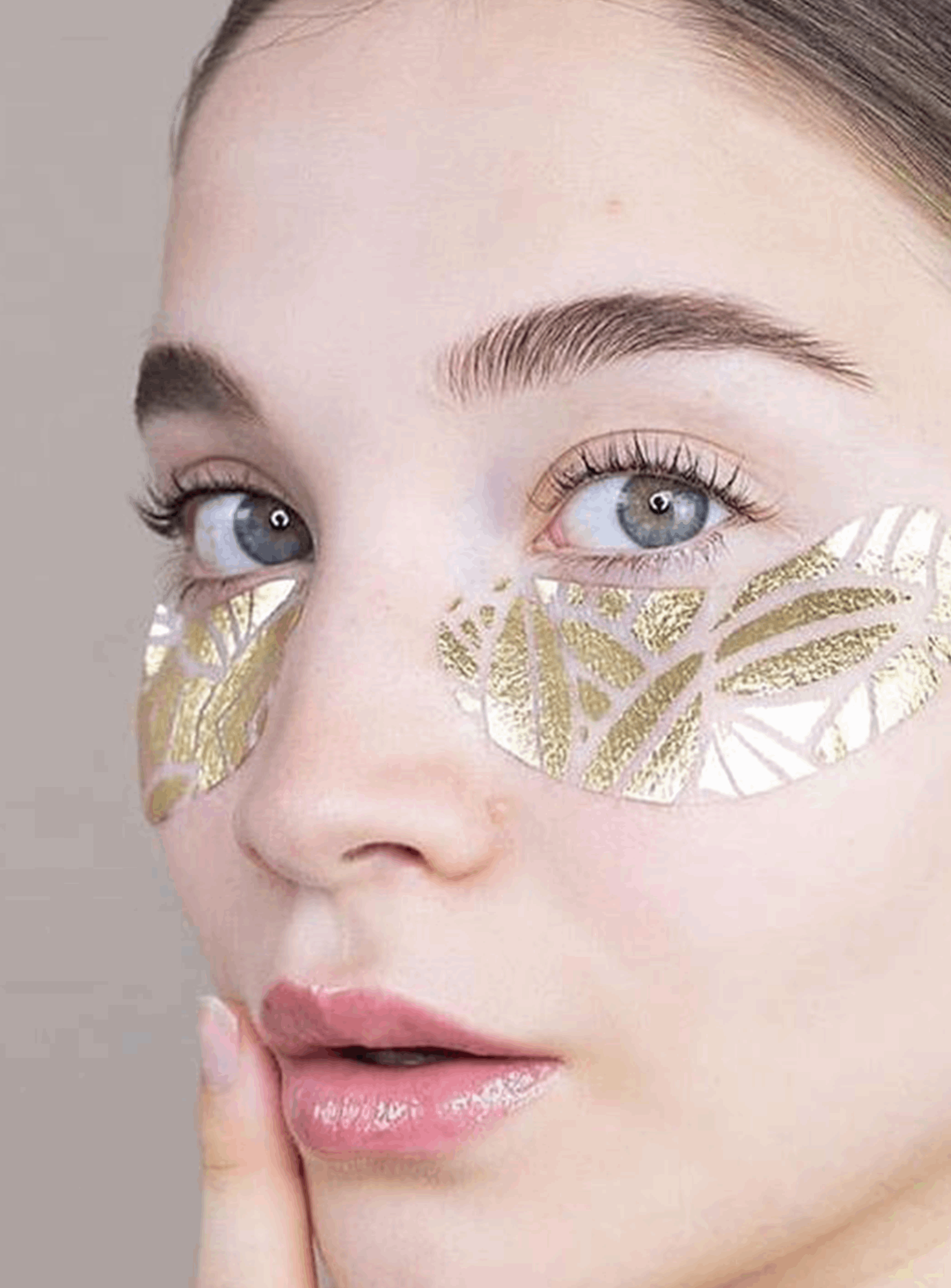 Close-up of a person wearing gold eye mask.