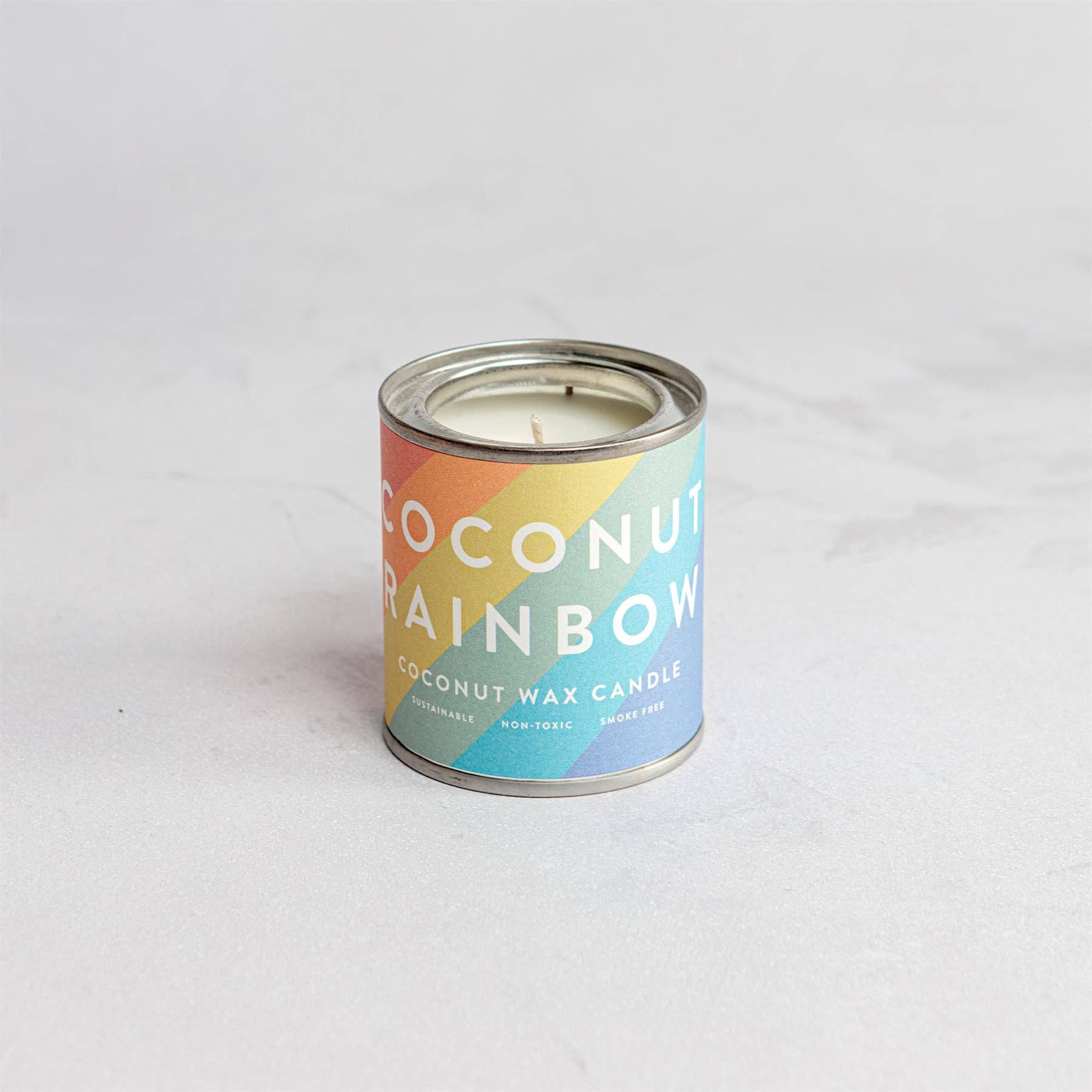 Coconut Rainbow candle in a tin.