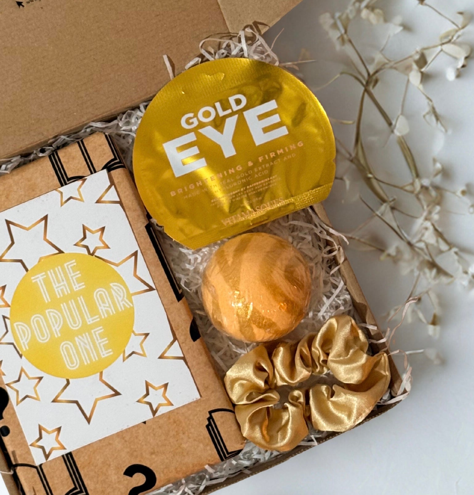 blind date with a book gift box with eye maks, bath bomb and gold satin scrunchie