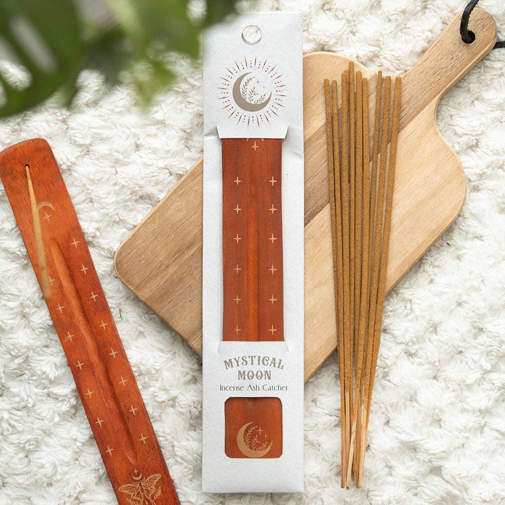 Mystical Moon wooden incense ash catcher with gold moon and star design, packaged in celestial-themed box featuring a crescent moon and radiant sunburst illustration.
