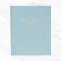 Light blue journal with 'The Thoughtful Journal' text in gold.