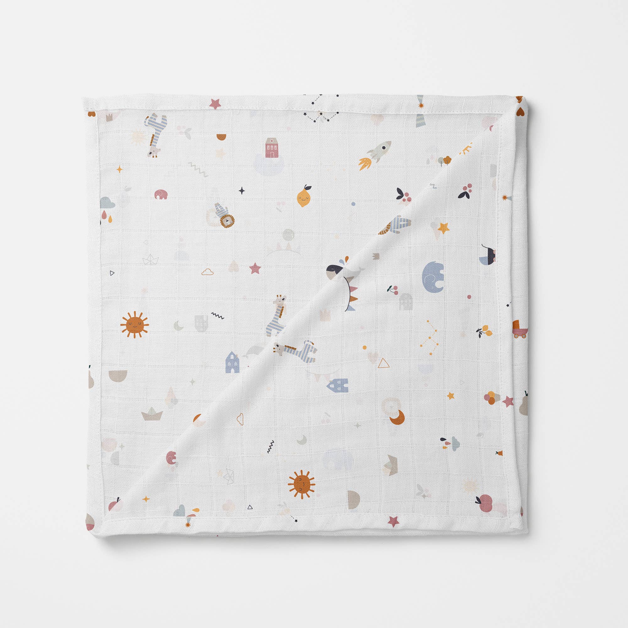 Soft white organic muslin swaddle blanket with playful outer space-themed print, featuring suns, rockets, planets, astronauts, stars, and whimsical icons.