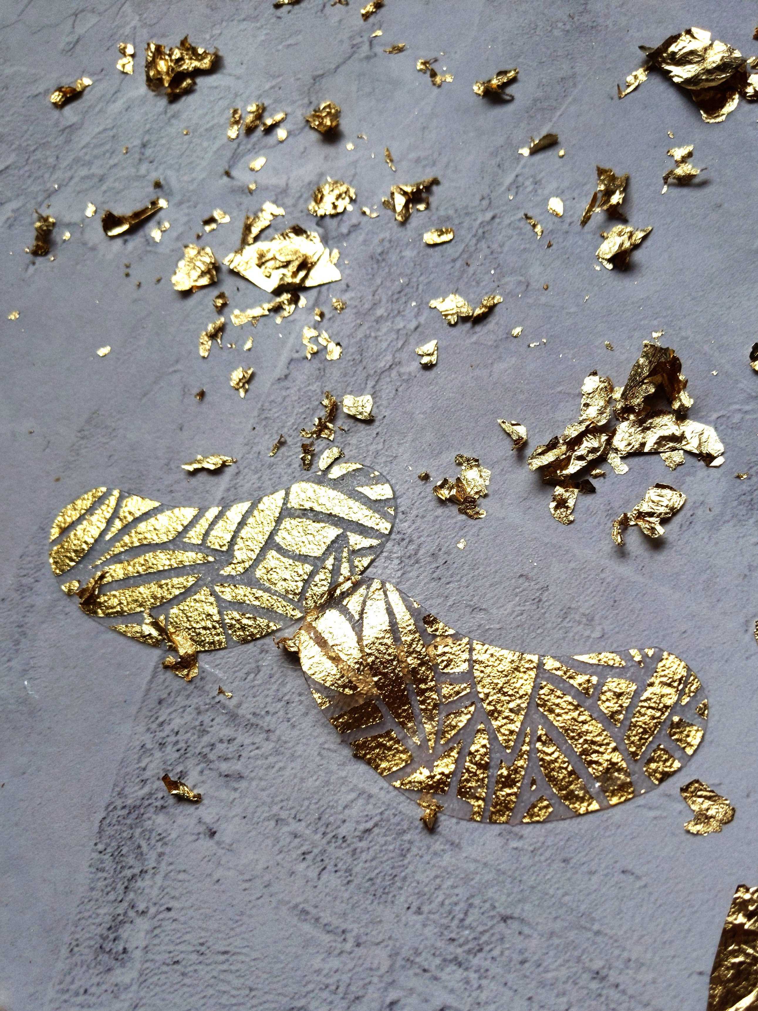 Gold leaf on a textured gray surface