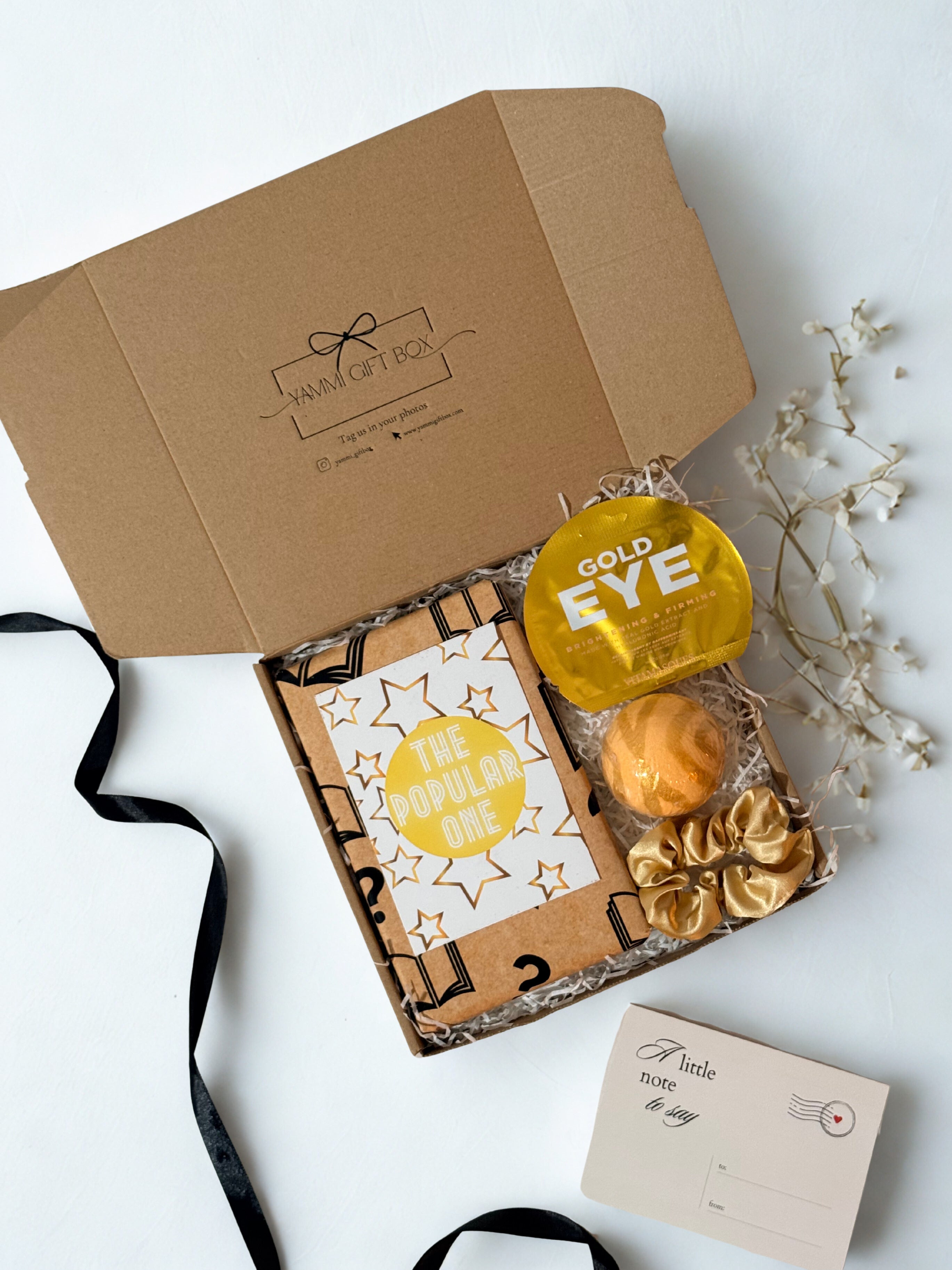 blind date with a book gift box with eye maks, bath bomb and gold satin scrunchie