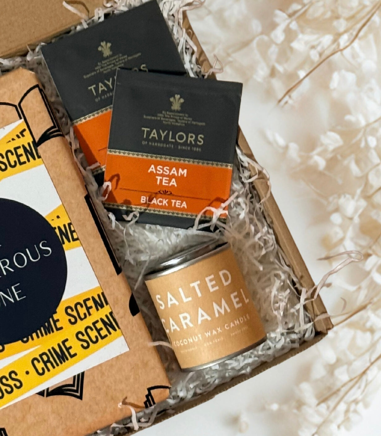 Tea boxes and a salted caramel candle in a gift box with a white background