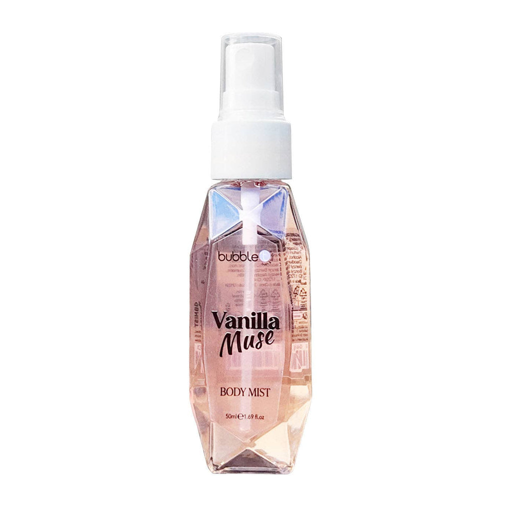 A 50ml Vanilla Muse Body Mist by Bubble T, housed in a faceted, gem-like clear plastic bottle with a soft peach-pink hue. The bottle features a white spray nozzle and cap, and minimalist black text on the front. Its modern, crystal-inspired design reflects light beautifully, giving it a luxurious, feminine appearance.
