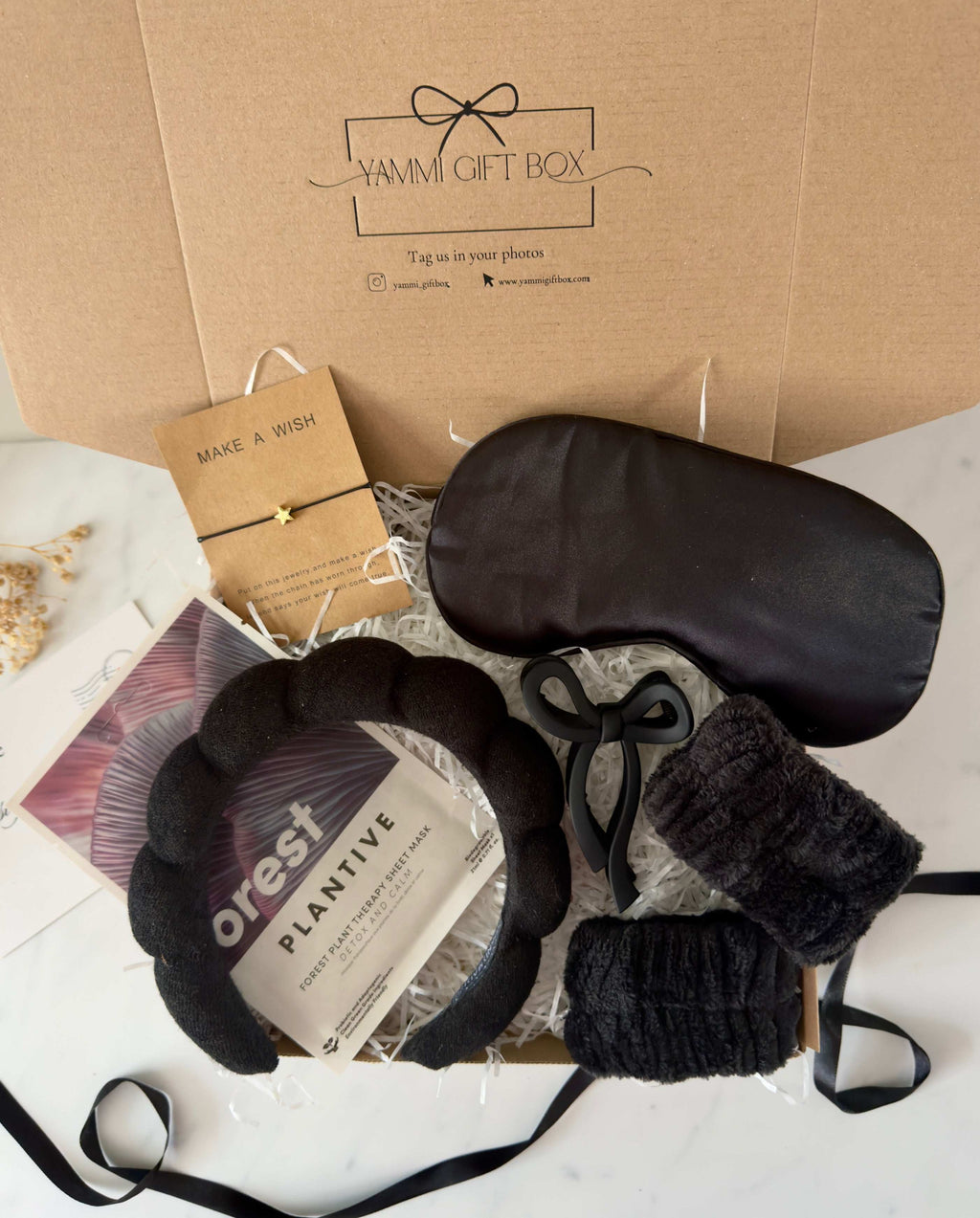 Yammie Gift Box with black eye mask, headband, and plant-based skincare.