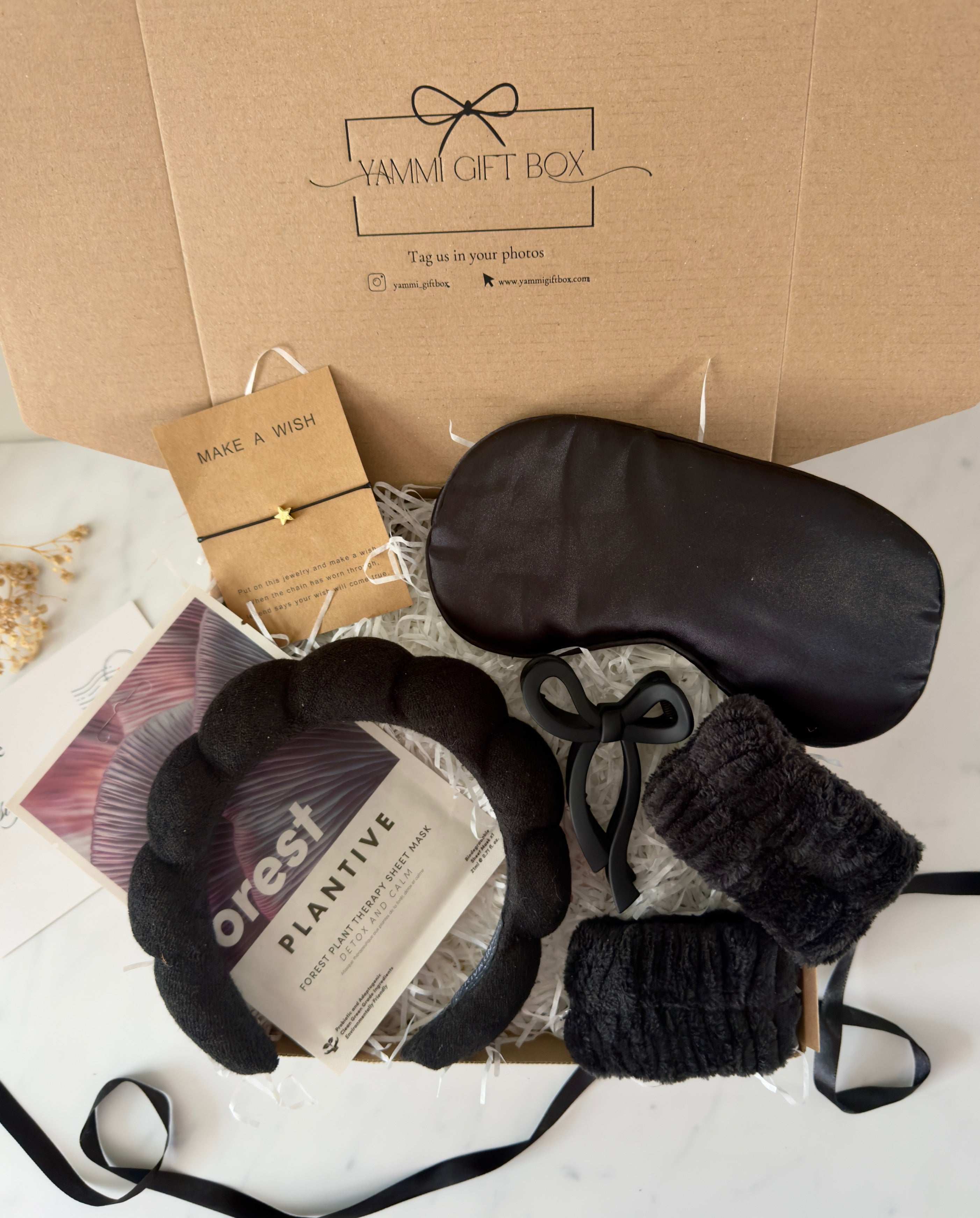 Yammie Gift Box with black eye mask, headband, and plant-based skincare.