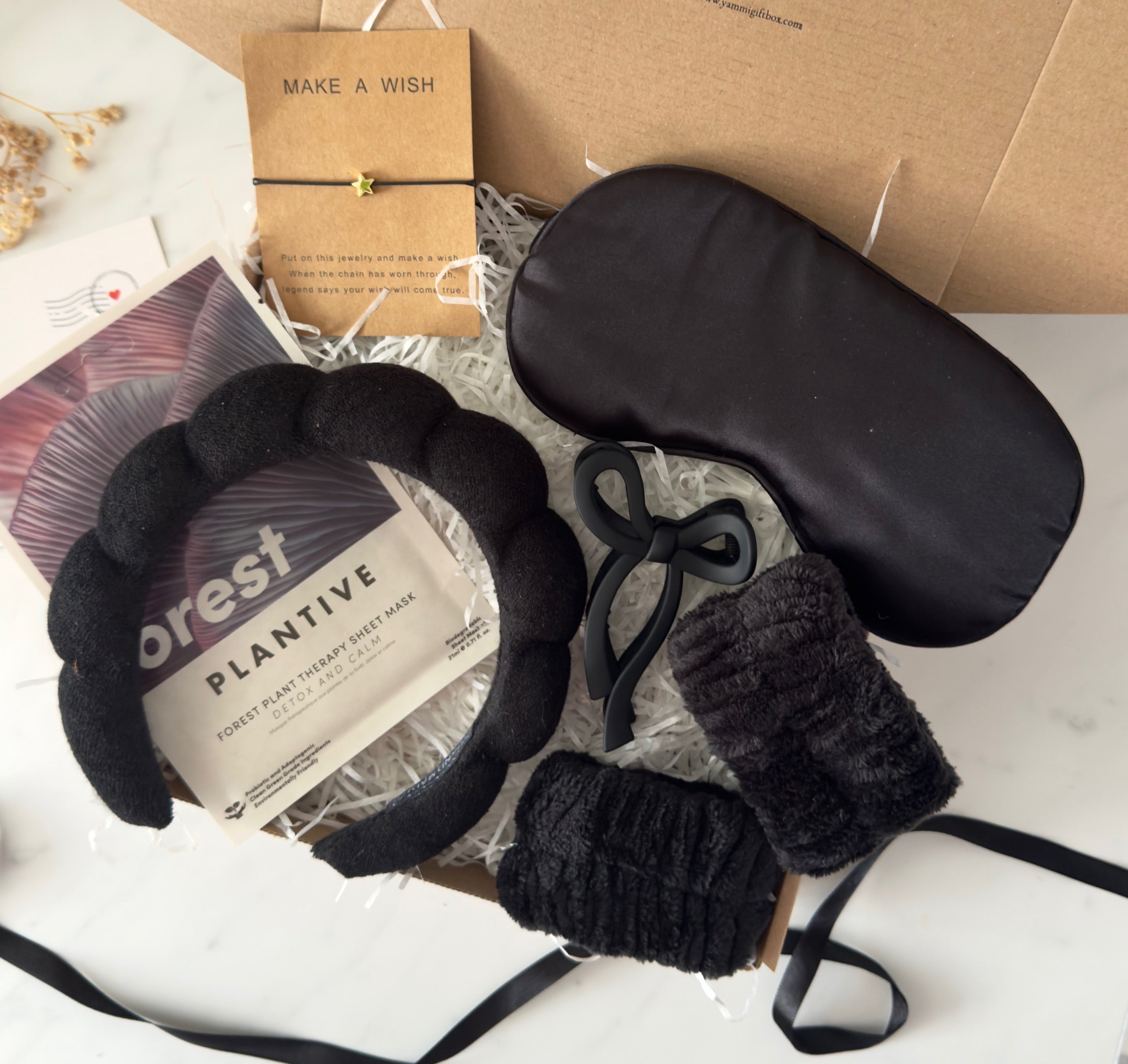 Black eye mask and headband with 'Forest Plantive' packaging.
