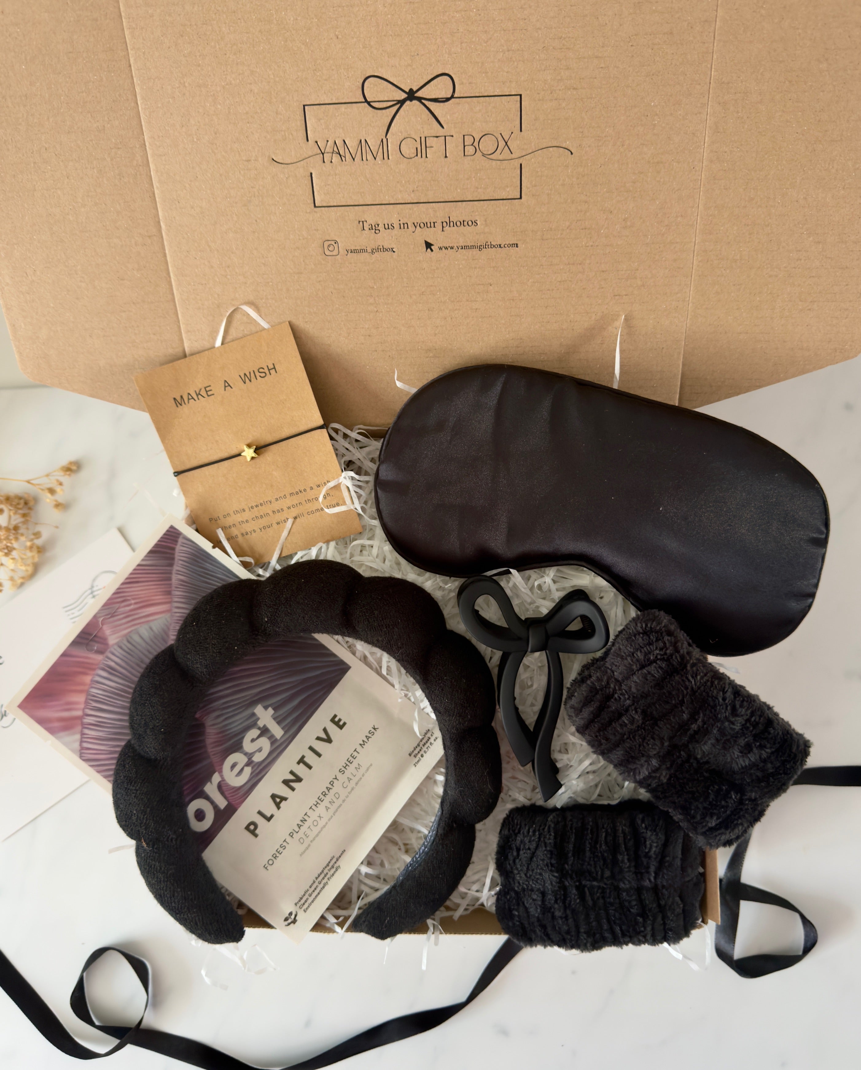Yammie Gift Box with black eye mask, headband, and plant-based skincare.