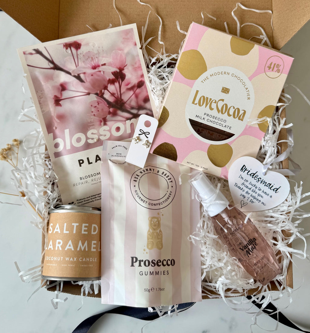 Gift set with chocolate, candles, and confectionery in a decorative box.