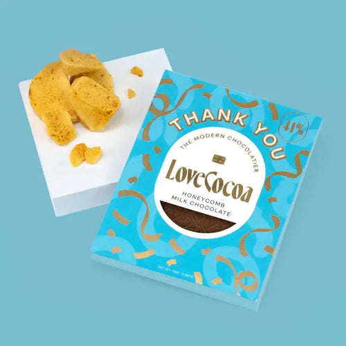 LoveCocoa honeycomb milk chocolate packaging with honeycomb pieces on a blue background