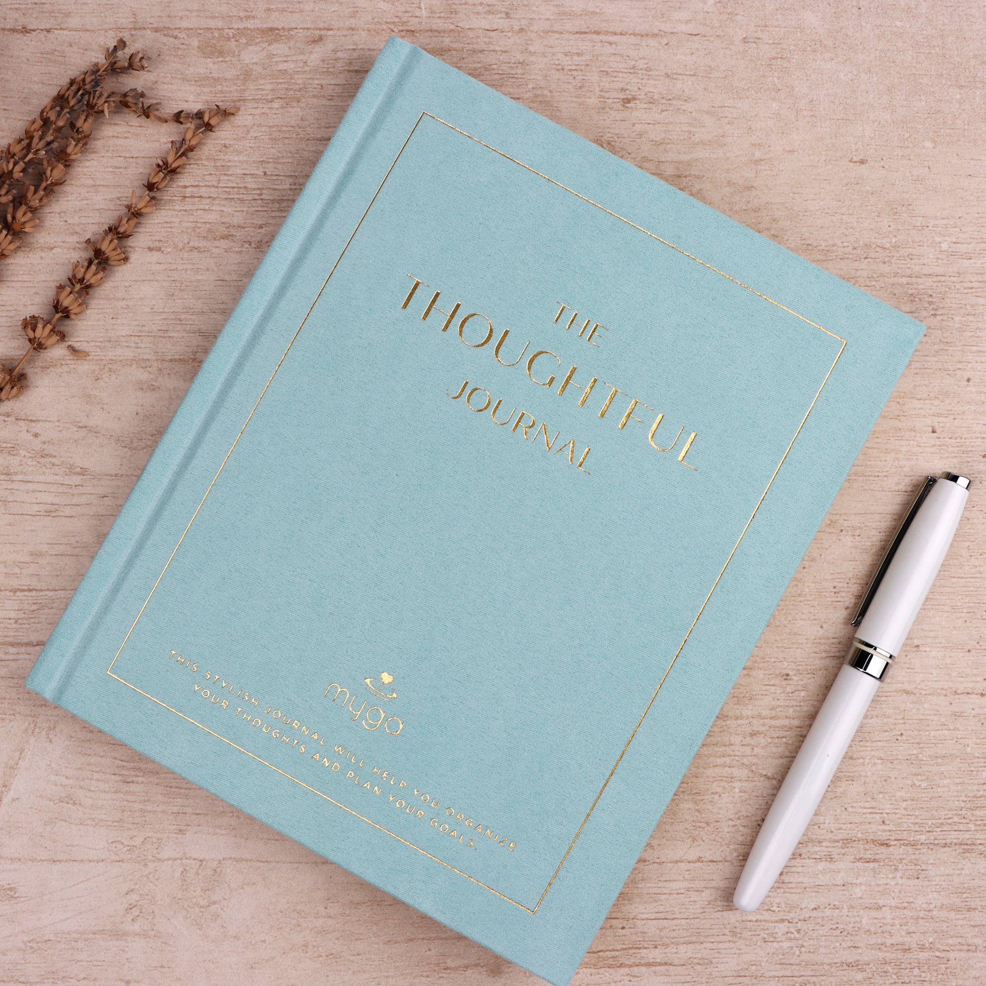 Light blue journal titled 'The Thoughtful Journal' with a white pen.