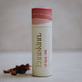 Lip balm container with 'Enniskinn' branding.