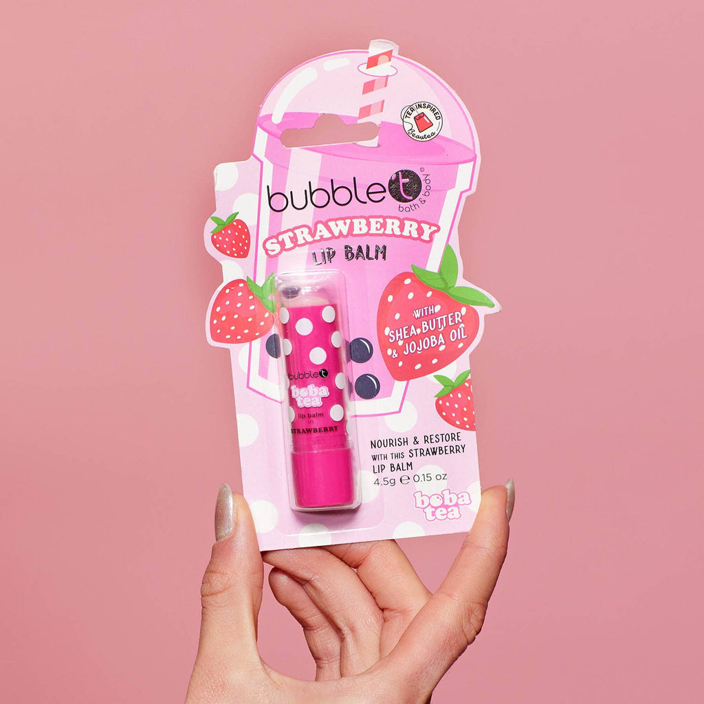 Pink strawberry lip balm with packaging.