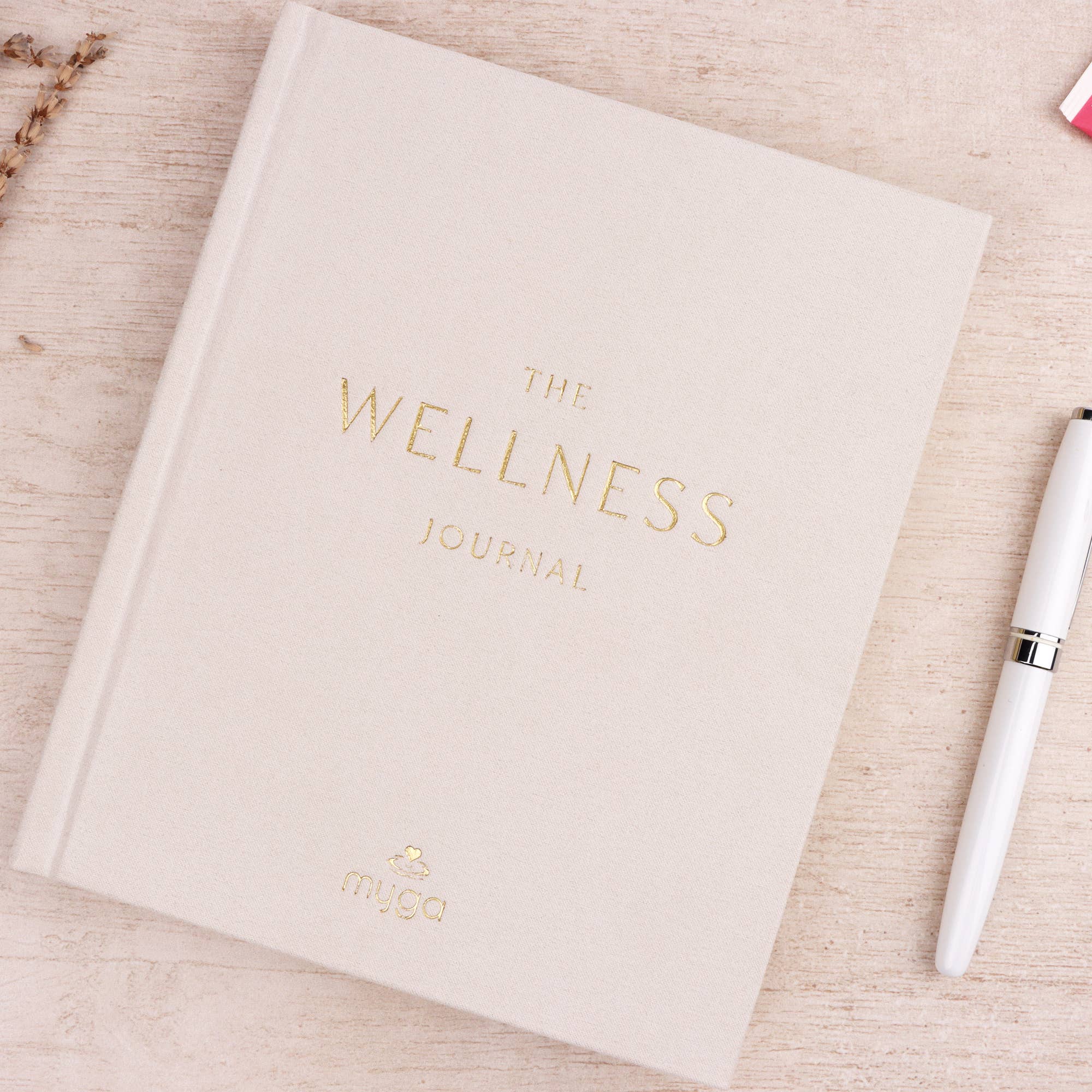 Wellness journal with a pen.